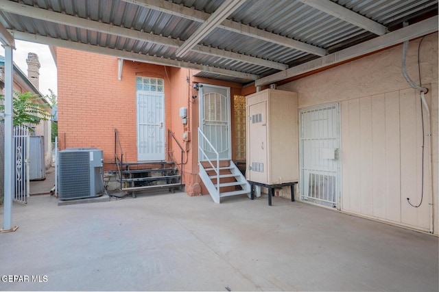 property entrance with central AC and a patio