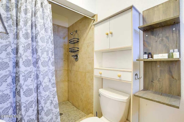 bathroom with toilet and walk in shower