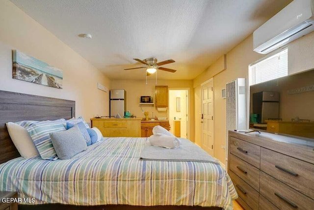 bedroom with an AC wall unit, ceiling fan, and a textured ceiling