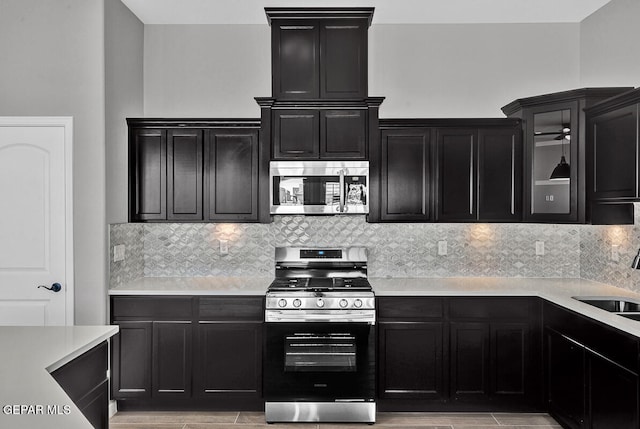 kitchen featuring appliances with stainless steel finishes, decorative backsplash, and sink