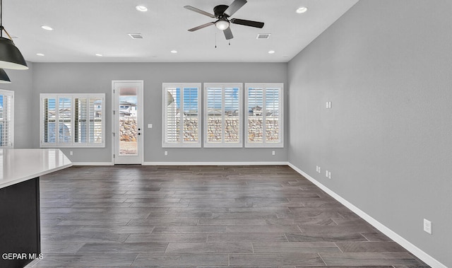 unfurnished living room with ceiling fan and dark hardwood / wood-style floors