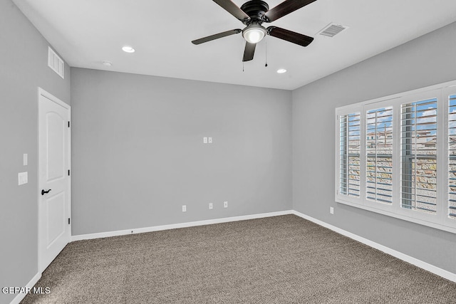 spare room featuring carpet and ceiling fan