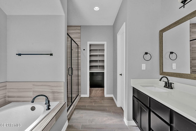 bathroom with vanity, wood-type flooring, and separate shower and tub