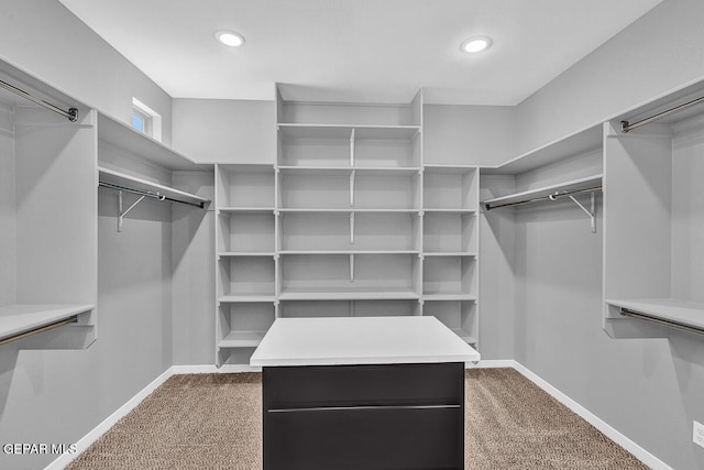 walk in closet featuring carpet flooring