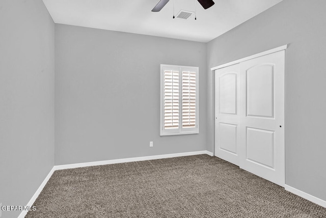 unfurnished bedroom featuring a closet, carpet, and ceiling fan