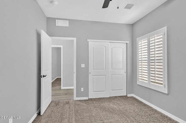 unfurnished bedroom featuring a closet, ceiling fan, and carpet floors