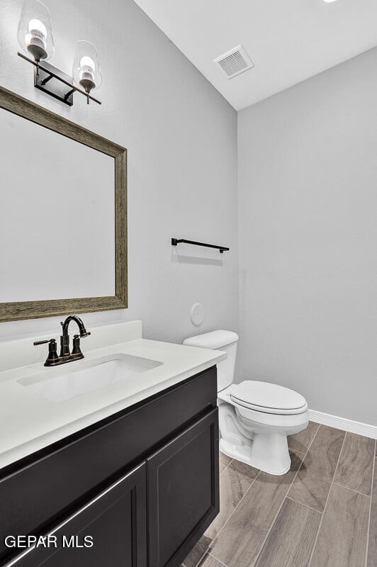 bathroom featuring vanity and toilet