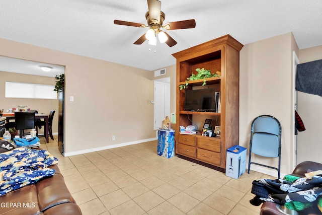 tiled living room with ceiling fan