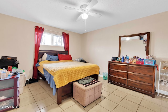 tiled bedroom with a textured ceiling and ceiling fan