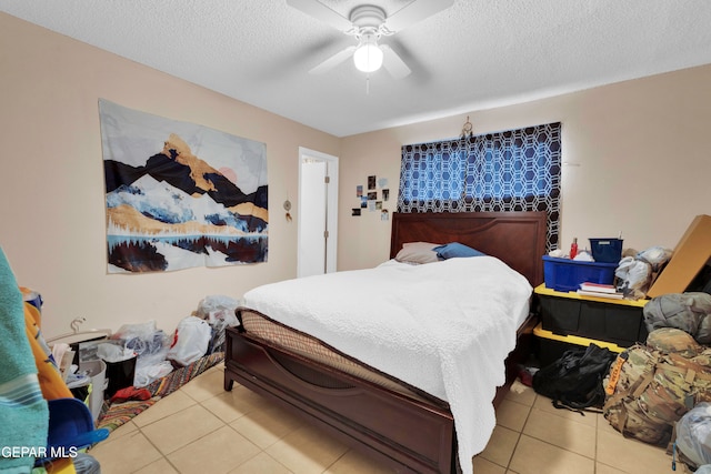 tiled bedroom featuring ceiling fan and a textured ceiling