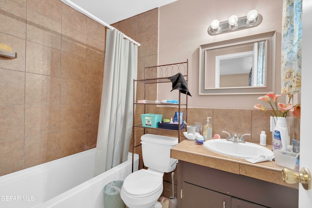 full bathroom with shower / bath combo, vanity, a textured ceiling, tile walls, and toilet