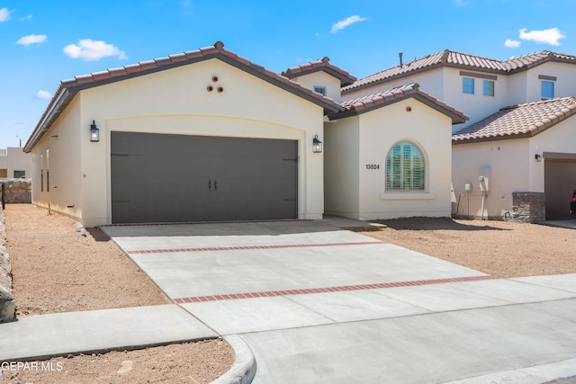 mediterranean / spanish-style home with a garage