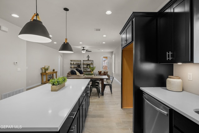 kitchen featuring light hardwood / wood-style floors, stainless steel dishwasher, hanging light fixtures, and ceiling fan