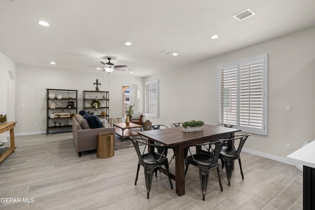 dining area with light hardwood / wood-style floors and ceiling fan