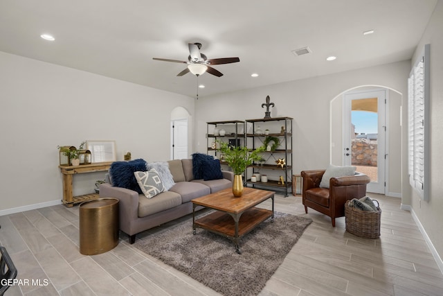 living room with light hardwood / wood-style floors and ceiling fan