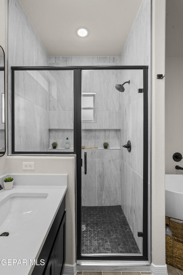 bathroom with vanity and a shower with shower door