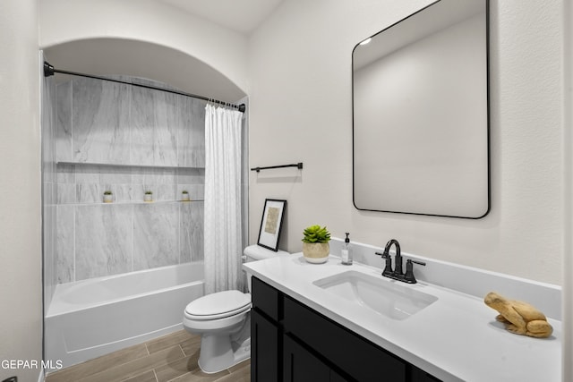 full bathroom featuring vanity, toilet, hardwood / wood-style flooring, and shower / tub combo