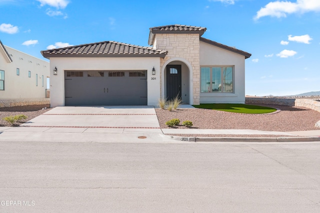 13653 Prime Vista Ct, El Paso, TX 79928 - mediterranean / spanish-style home with stone siding, stucco siding, a garage, driveway, and a tiled roof