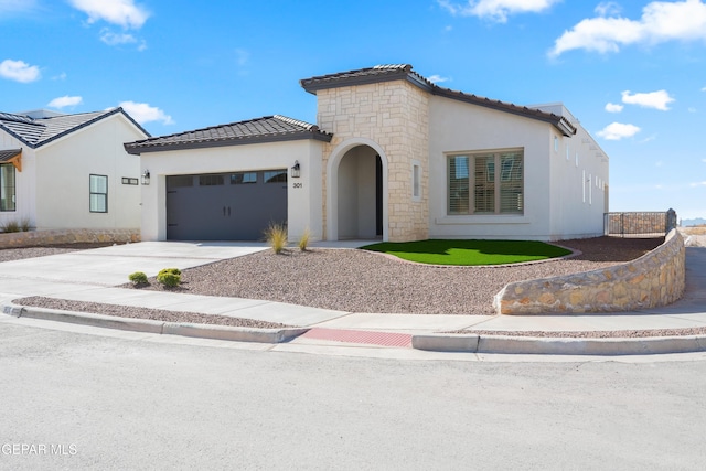13653 Prime Vista Ct, El Paso, TX 79928 - mediterranean / spanish-style home featuring driveway, an attached garage, stone siding, stucco siding, and a tile roof