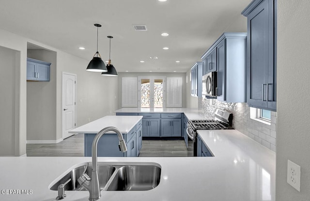13653 Prime Vista Ct, El Paso, TX 79928 - kitchen featuring appliances with stainless steel finishes, light wood finished floors, light countertops, decorative backsplash, and recessed lighting
