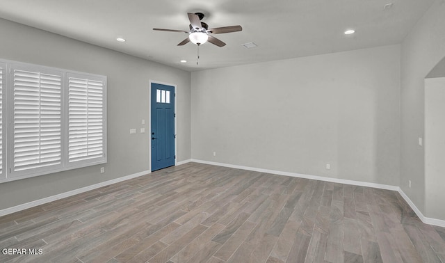 foyer entrance with light hardwood / wood-style floors and ceiling fan