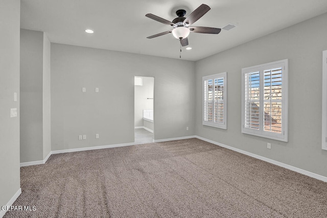 empty room featuring ceiling fan and carpet