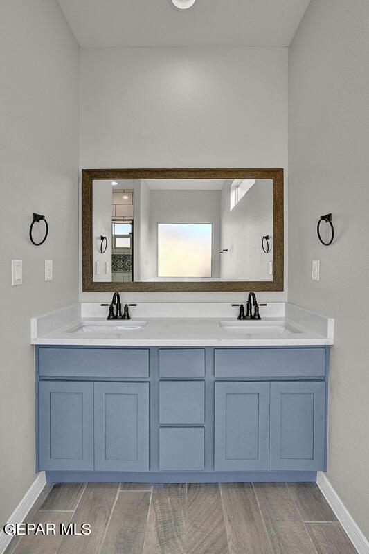 13653 Prime Vista Ct, El Paso, TX 79928 - bathroom featuring double vanity and wood finished floors