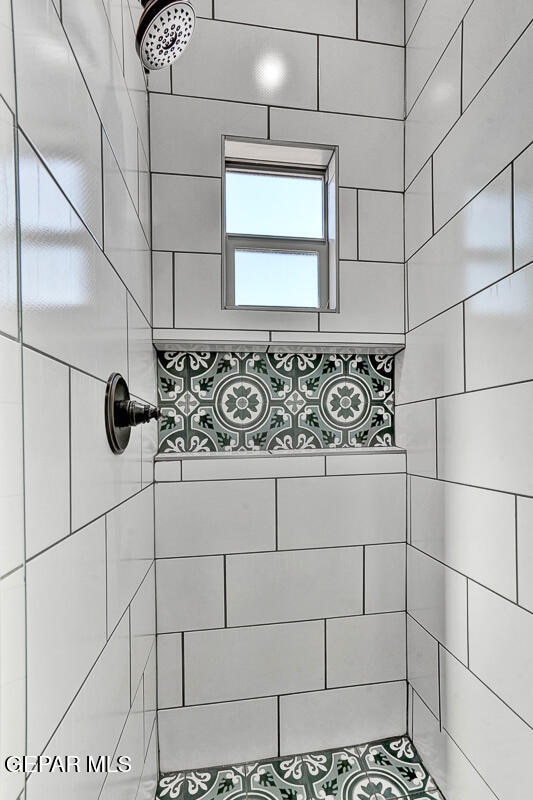 bathroom with a tile shower