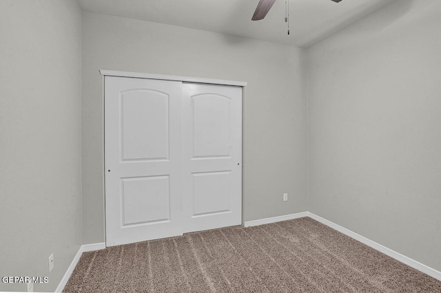 unfurnished bedroom featuring carpet flooring, a closet, and ceiling fan