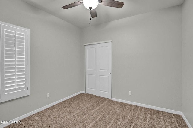 spare room with carpet and ceiling fan