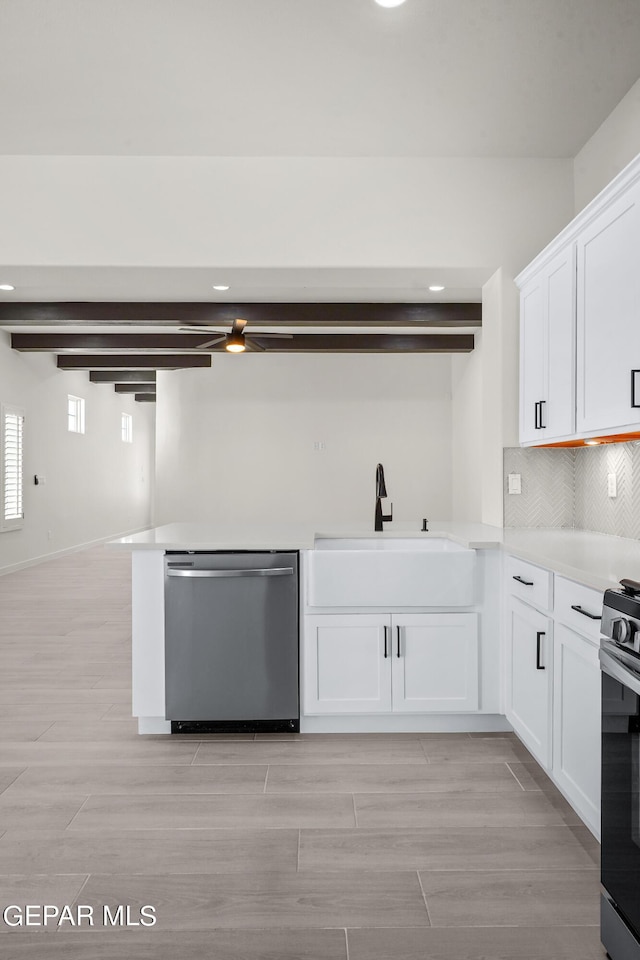 13866 Paseo Central Ave, El Paso, TX 79928 - kitchen with appliances with stainless steel finishes, a sink, white cabinetry, tasteful backsplash, and light countertops