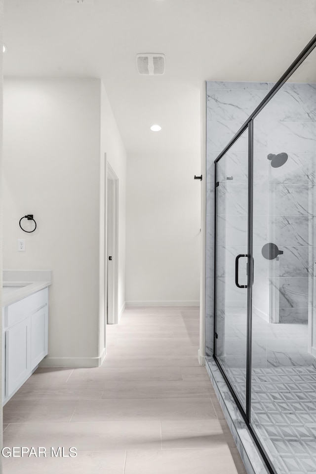 13866 Paseo Central Ave, El Paso, TX 79928 - bathroom featuring a marble finish shower, vanity, baseboards, and recessed lighting