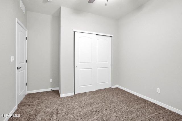 unfurnished bedroom featuring ceiling fan, carpet floors, and a closet