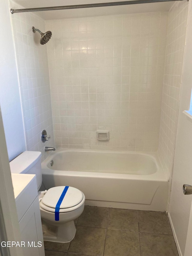 full bathroom with toilet, tiled shower / bath, vanity, and tile patterned floors