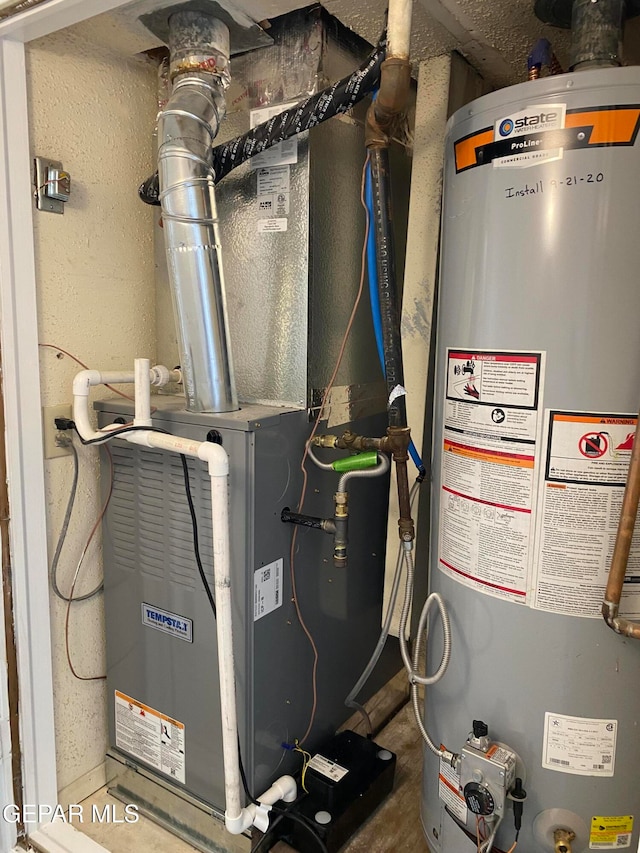 utility room featuring gas water heater