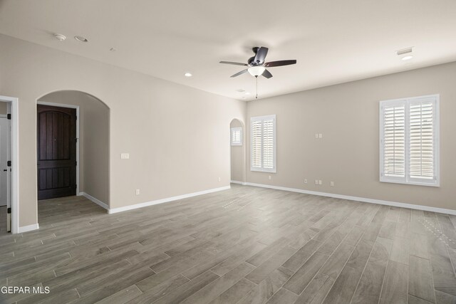 spare room featuring ceiling fan and wood-type flooring