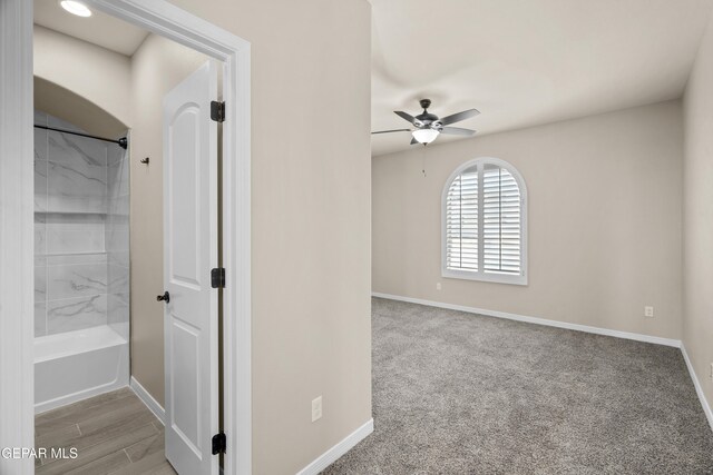 hallway featuring light colored carpet