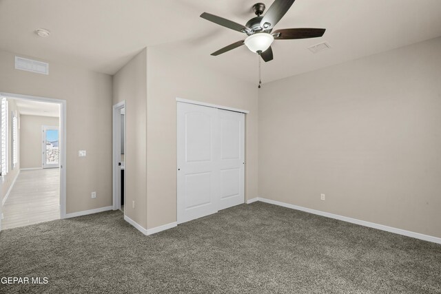 unfurnished bedroom with a closet, ceiling fan, and carpet floors