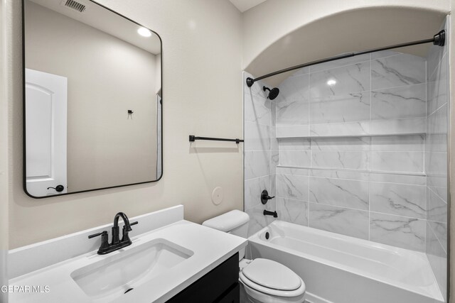 full bathroom featuring vanity, toilet, and tiled shower / bath