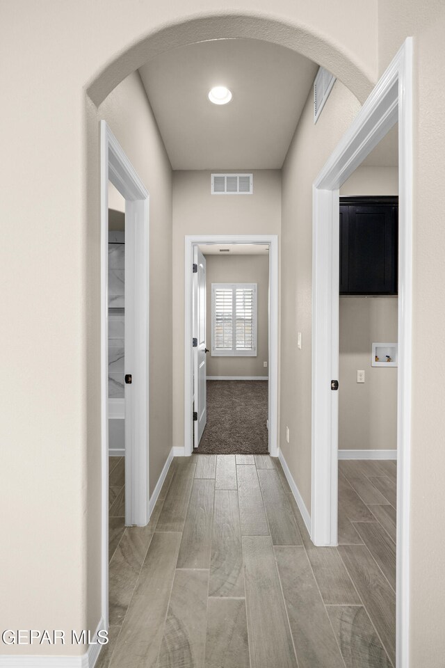 hallway with light hardwood / wood-style flooring