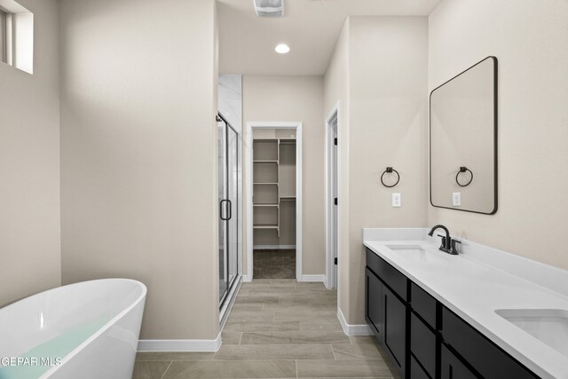 bathroom featuring vanity and plus walk in shower