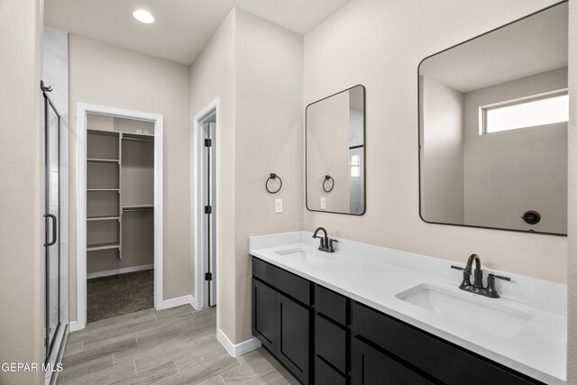 bathroom featuring vanity, an enclosed shower, and hardwood / wood-style floors