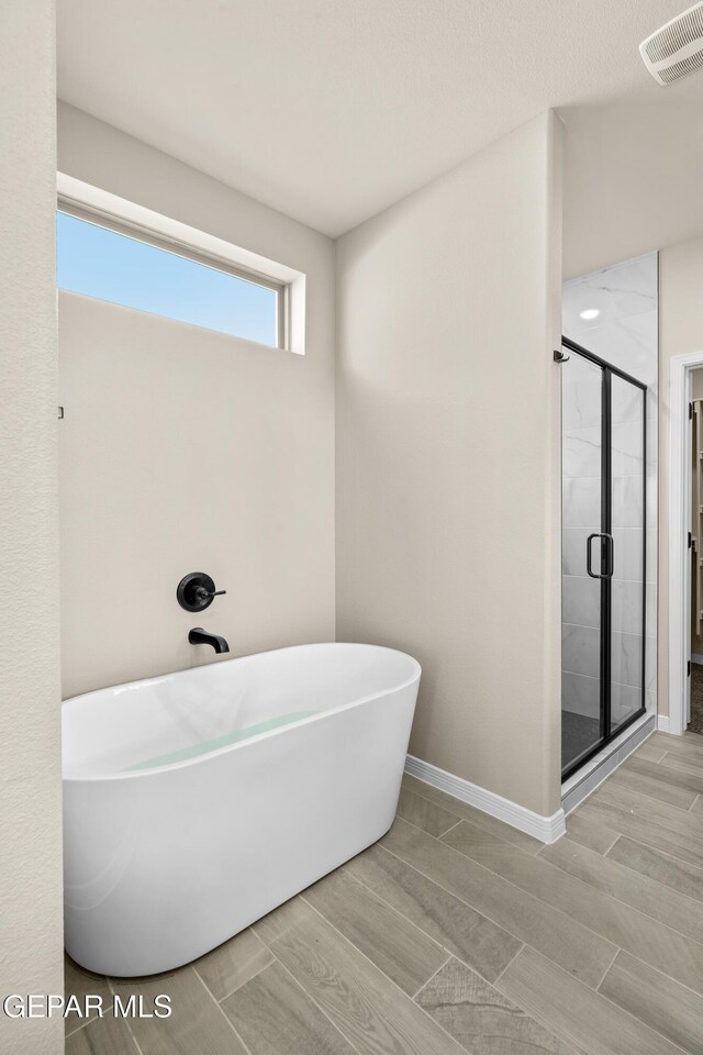 bathroom with separate shower and tub