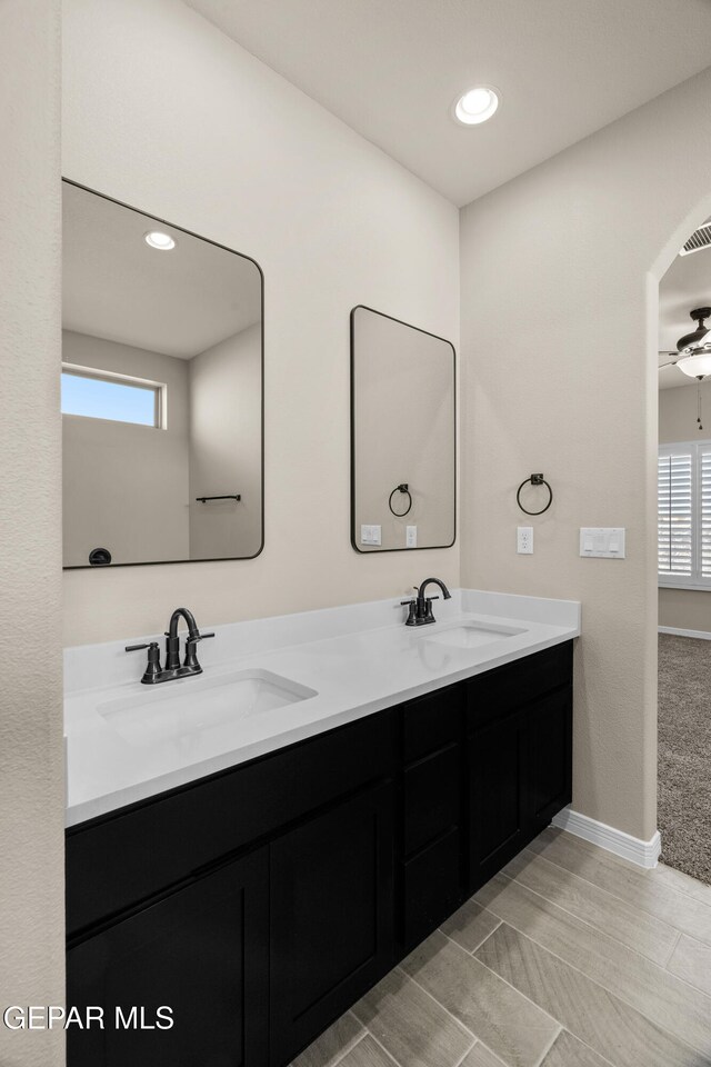 bathroom featuring a wealth of natural light, vanity, and ceiling fan