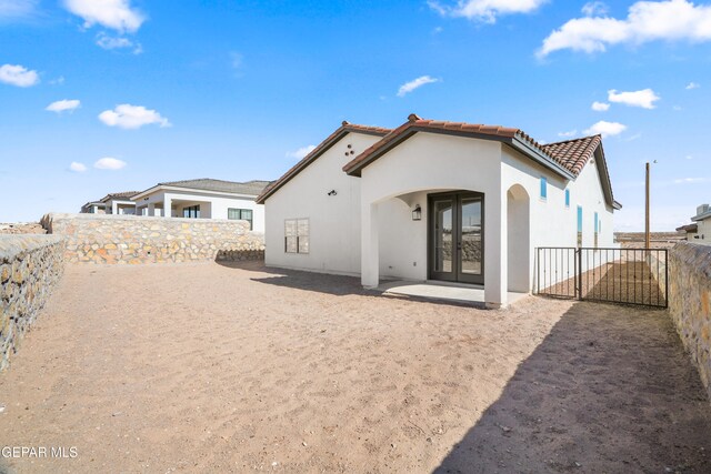 rear view of house featuring french doors