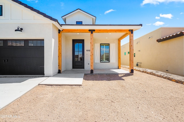 view of front of home featuring a garage and a porch