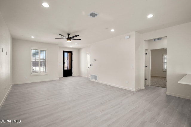 empty room featuring light wood-type flooring and ceiling fan