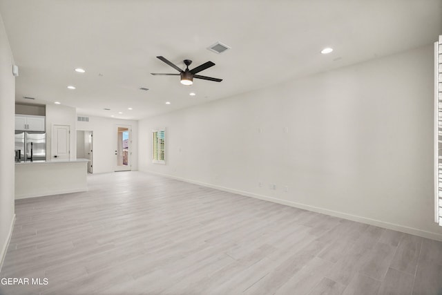 unfurnished living room with light hardwood / wood-style floors and ceiling fan