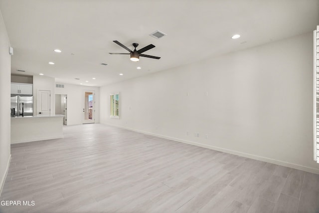 13870 Paseo Central Ave, Horizon City, TX 79928 - unfurnished living room with ceiling fan, recessed lighting, light wood finished floors, and baseboards