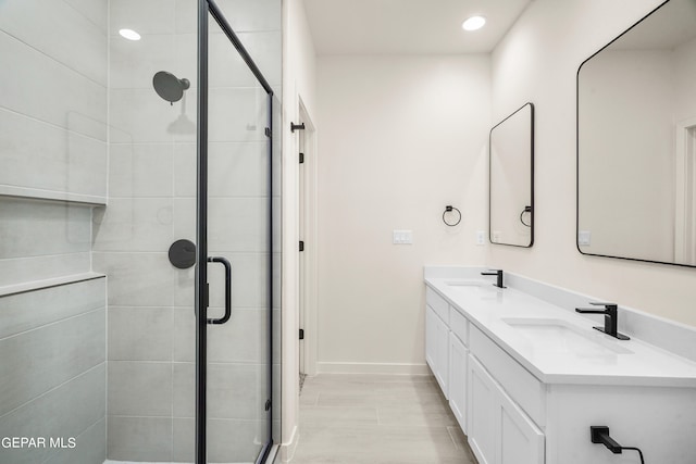 bathroom with a shower with door, vanity, and wood-type flooring